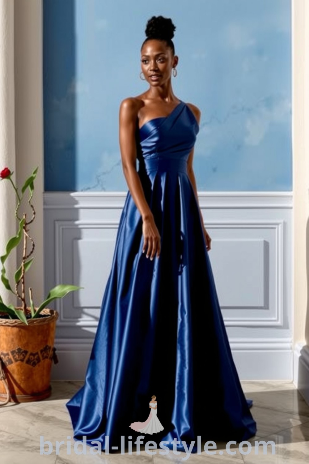 One-shoulder blue bridesmaid dress in luxurious satin with an A-line skirt and delicate pleating, designed for brides looking for elegance and refinement on their special day. bridal-lifestyle.com