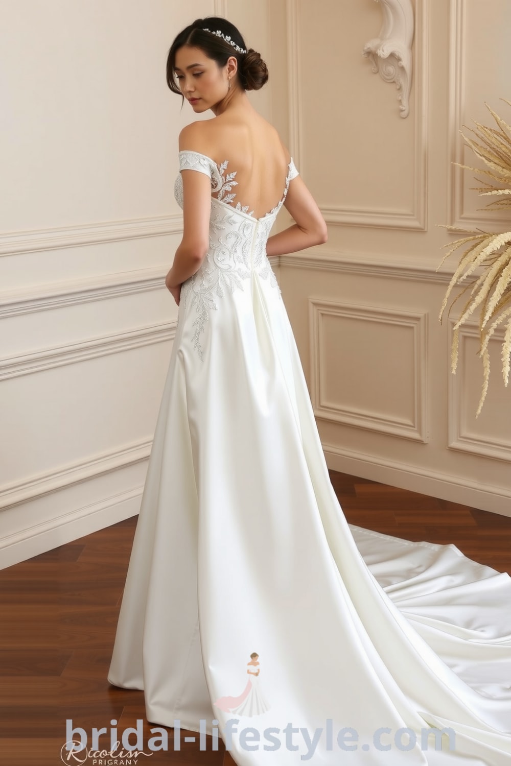 A-line wedding dress with a sweetheart neckline, embroidered lace bodice, flowing satin skirt, and pearl accents on the back. bridal-lifestyle.com