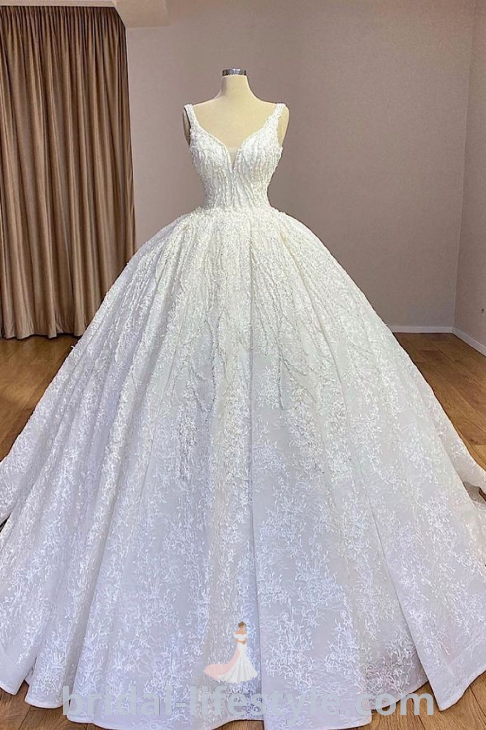 An elegant white ball gown on display in a room with wooden floors and curtains, showcasing princess wedding dresses, satin mermaid wedding dress styles, and beautiful bridal dresses. Explore classy aesthetics for every bride