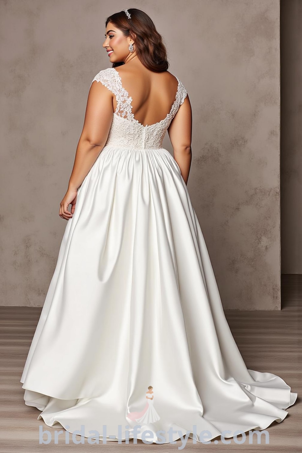 A-line wedding dress designed for plus-size brides, featuring a luxurious satin skirt, intricate lace bodice with floral appliqués, sweetheart neckline, chiffon overlay, and satin-covered buttons at the back. bridal-lifestyle.com