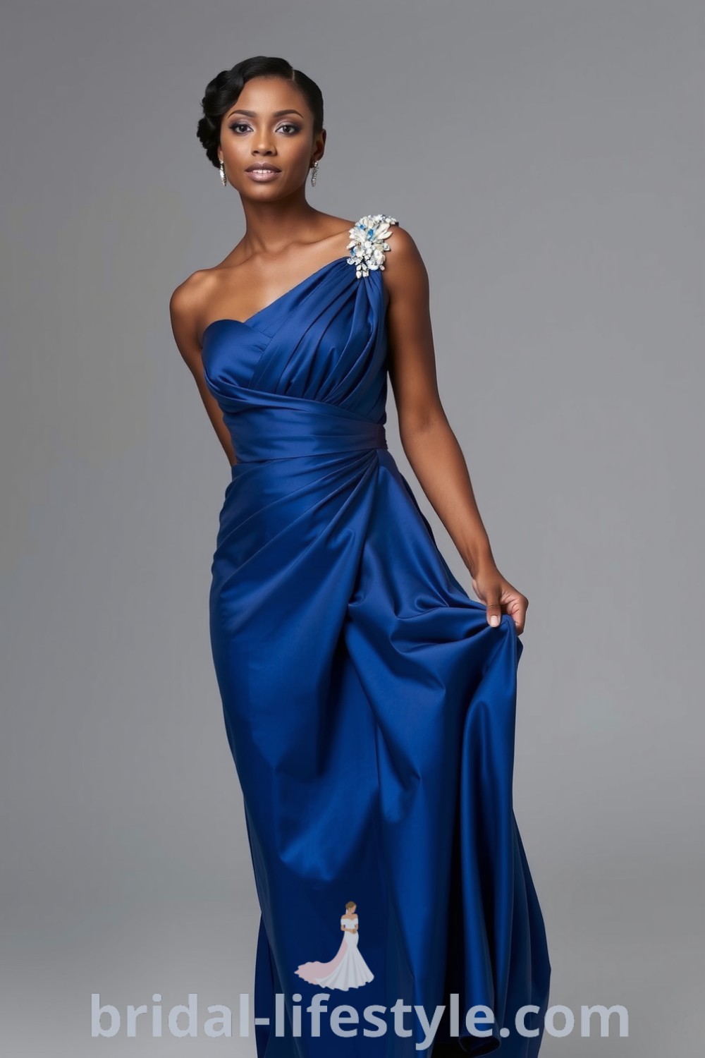 Elegant one-shoulder blue bridesmaid dress made of satin, featuring intricate beadwork and a graceful floor-length silhouette, perfect for a sophisticated celebration. bridal-lifestyle.com