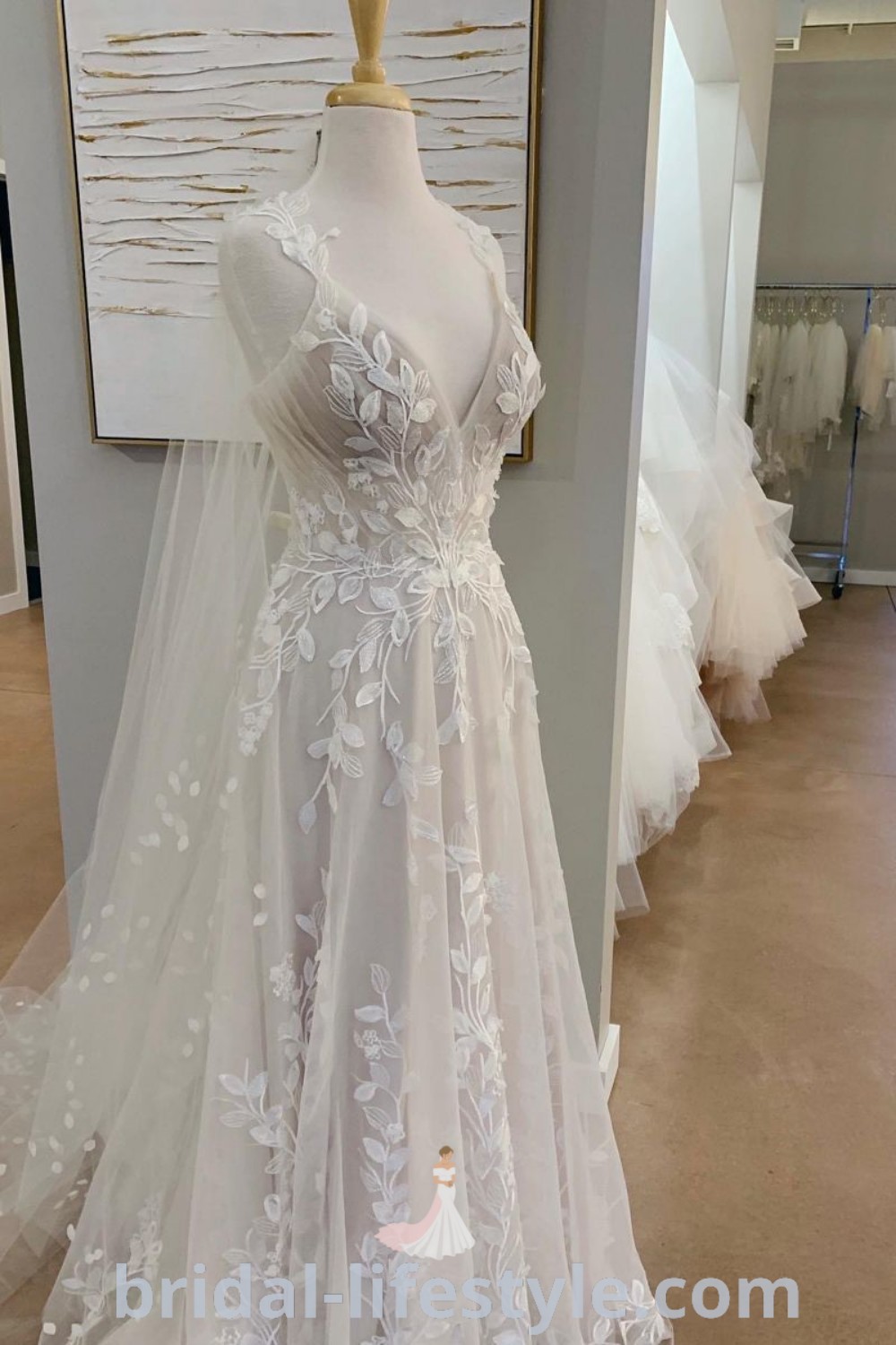 A white whimsical wedding dress on display at a bridal gown shop featuring vine embroidery and leafy details, ideal for romantic and nature-inspired brides. Discover the best dresses for every bride