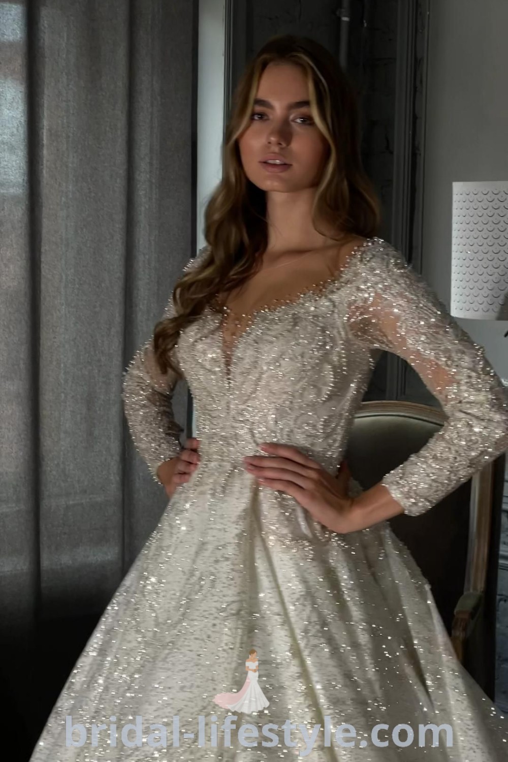 A glitter wedding dress with long sleeves, perfect for brides looking for stylish and unique wedding dress inspiration. This gown embodies elegance and glam with bling, making it suitable for every bride