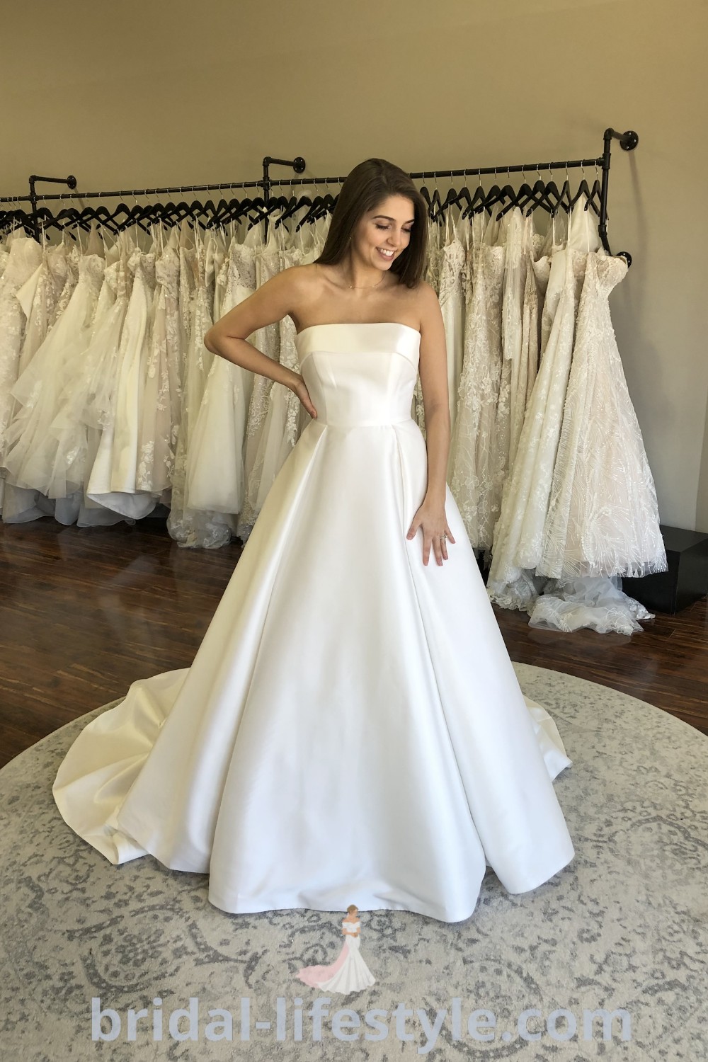 A beautiful woman standing in front of various wedding dresses including classic A Line Wedding Dress Satin, Simple Satin Wedding Dress Ballgown, and Strapless Satin Wedding Dress Ballgown. This image showcases elegant options for brides at bridal-lifestyle.com, offering inspiration for every bride
