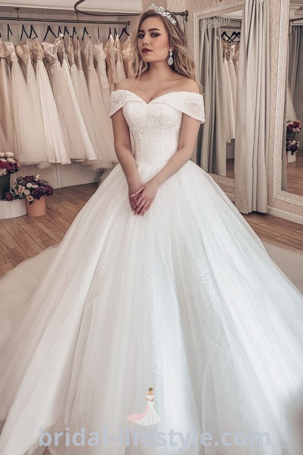 An elegant wedding dress with rhinestones showcased by a woman wearing a tiara, representing luxury and dreamy bridal trends. This stylish gown offers exquisite inspiration for every bride, perfect for the special day. Explore more at bridal-lifestyle.com.