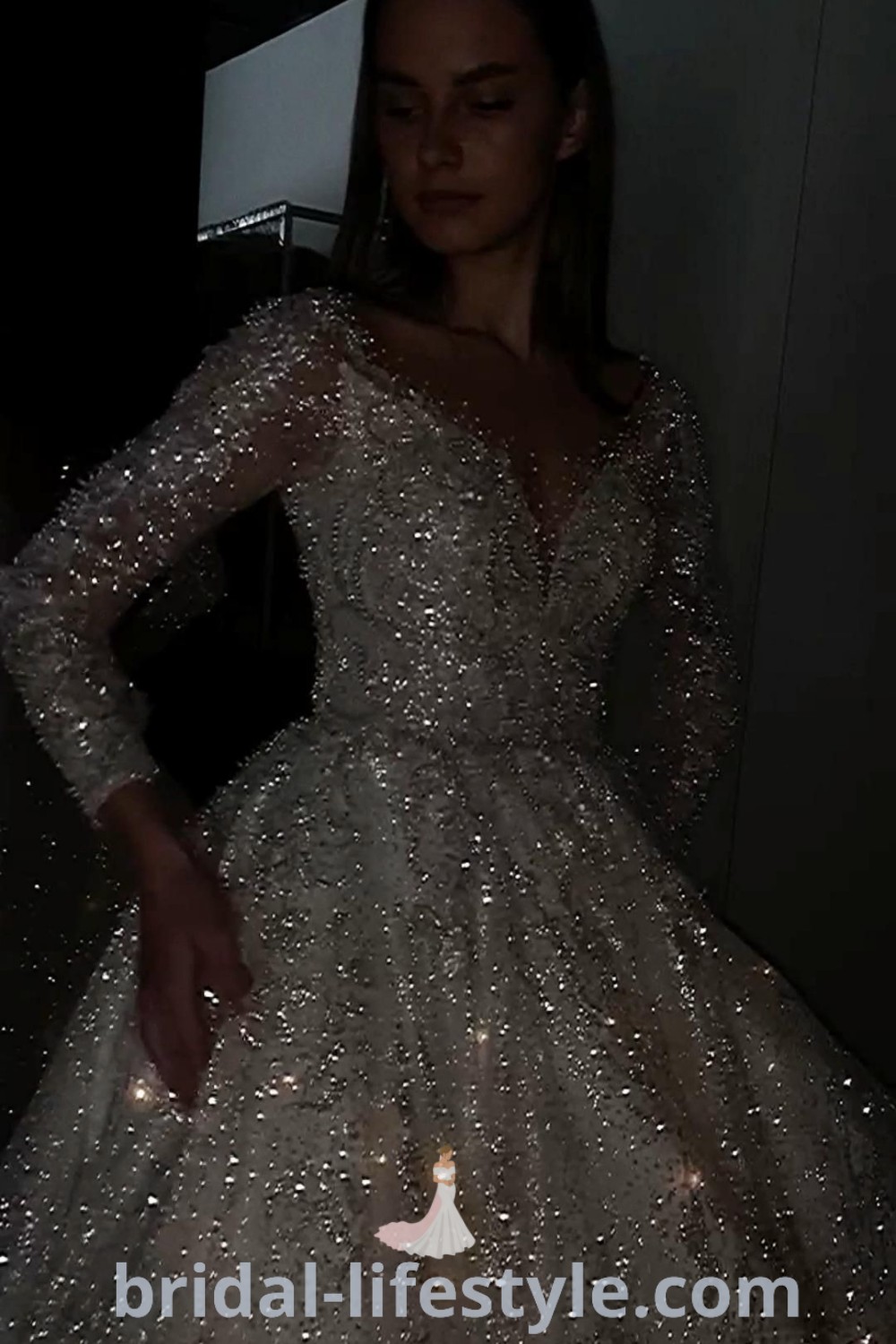 A sparkly long sleeve wedding dress ball gown featuring glittery details, ideal for romantic winter weddings. Perfect for dreamy brides, this elegant gown represents the best bridal trends for the special day. Experience the enchanting vibes with dresses of your dreams at bridal-lifestyle.com.
