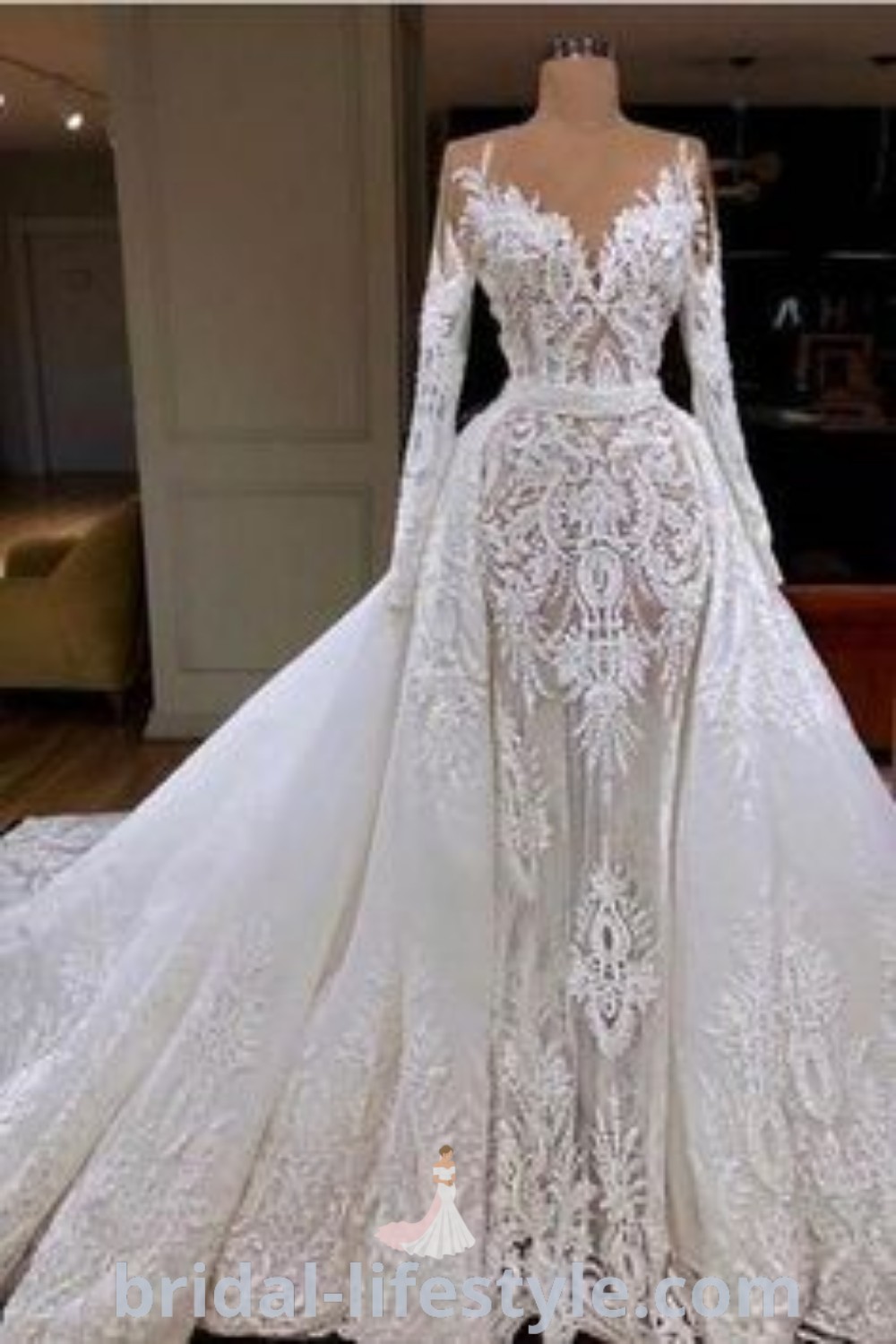 An elegant white wedding dress with long sleeves and lace details, showcased in front of a mannequin, perfect for dreamy brides looking for inspiration and trends for their special day. Explore the best bridal aesthetics at bridal-lifestyle.com.