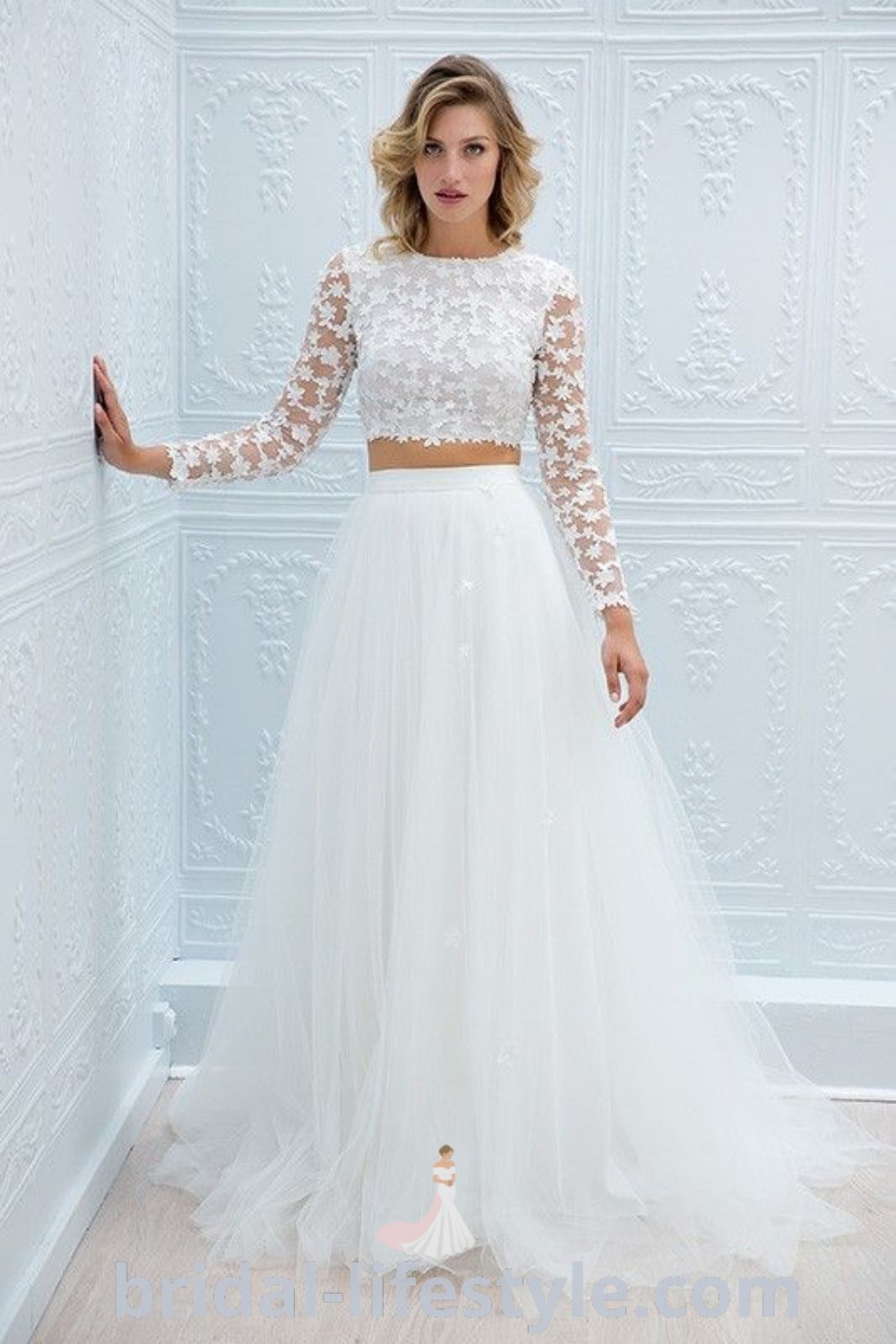 A woman in a stunning white wedding dress leaning against a wall, showcasing elegant bridal looks and inspiring trends for every bride’s unique taste. Explore more on bridal-lifestyle.com for the best wedding aesthetic ideas and dresses of your dreams.