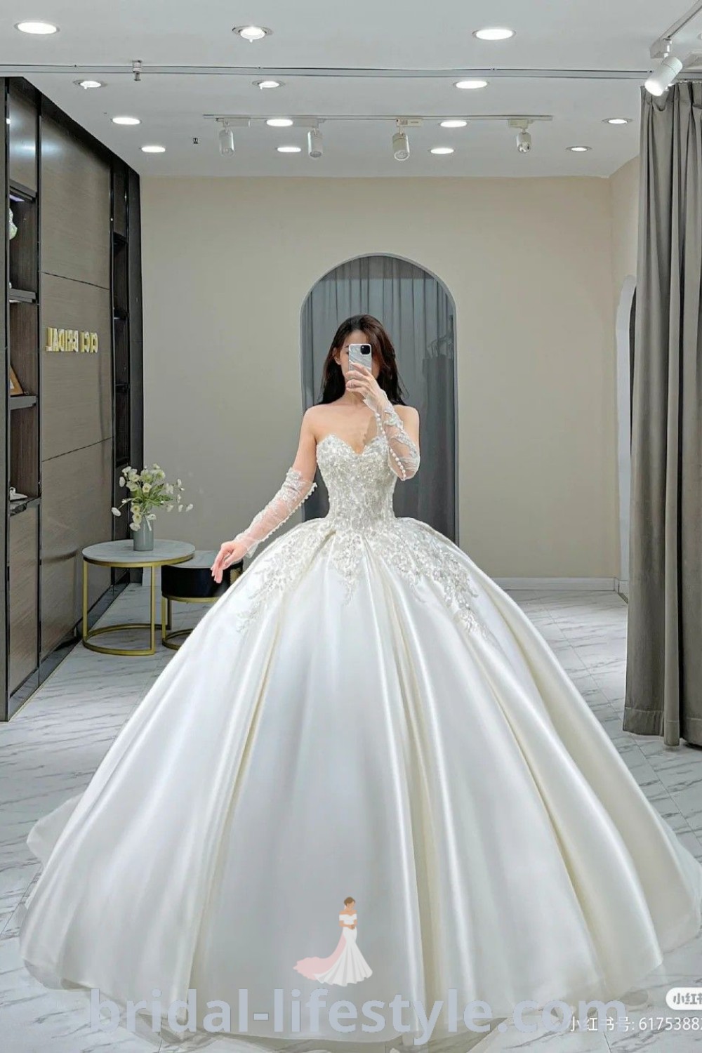 A woman in a big elegant white ballgown wedding dress is taking a selfie with her cell phone, showcasing the most beautiful wedding dresses for stylish brides. This moment captures the essence of bridal inspiration for every bride