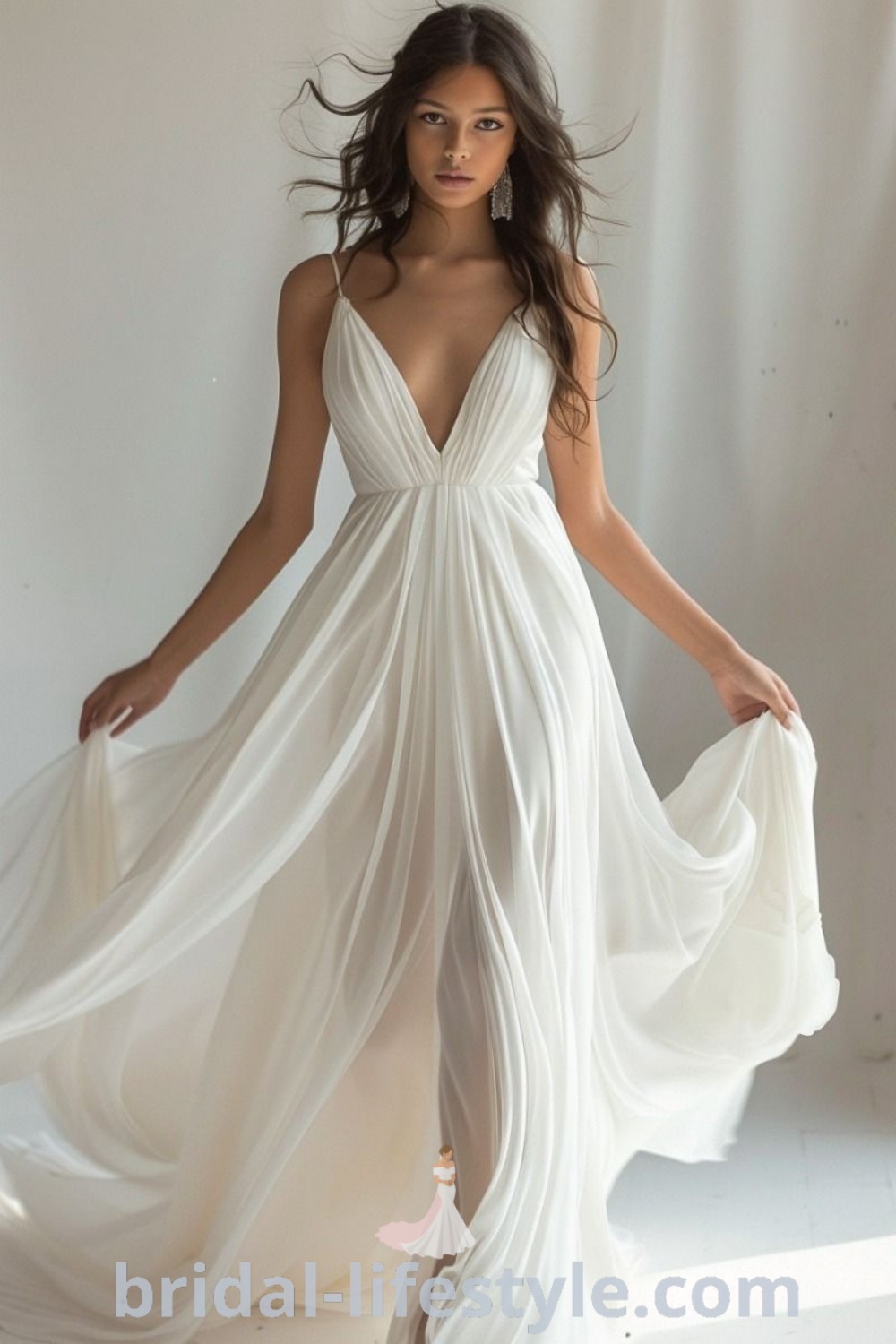 A woman in a white dress posing for the camera, showcasing a beachy boho wedding dress that blends elegance and casual charm. This modern gown is perfect for brides looking for Greek-style dress inspiration and is featured on bridal-lifestyle.com.