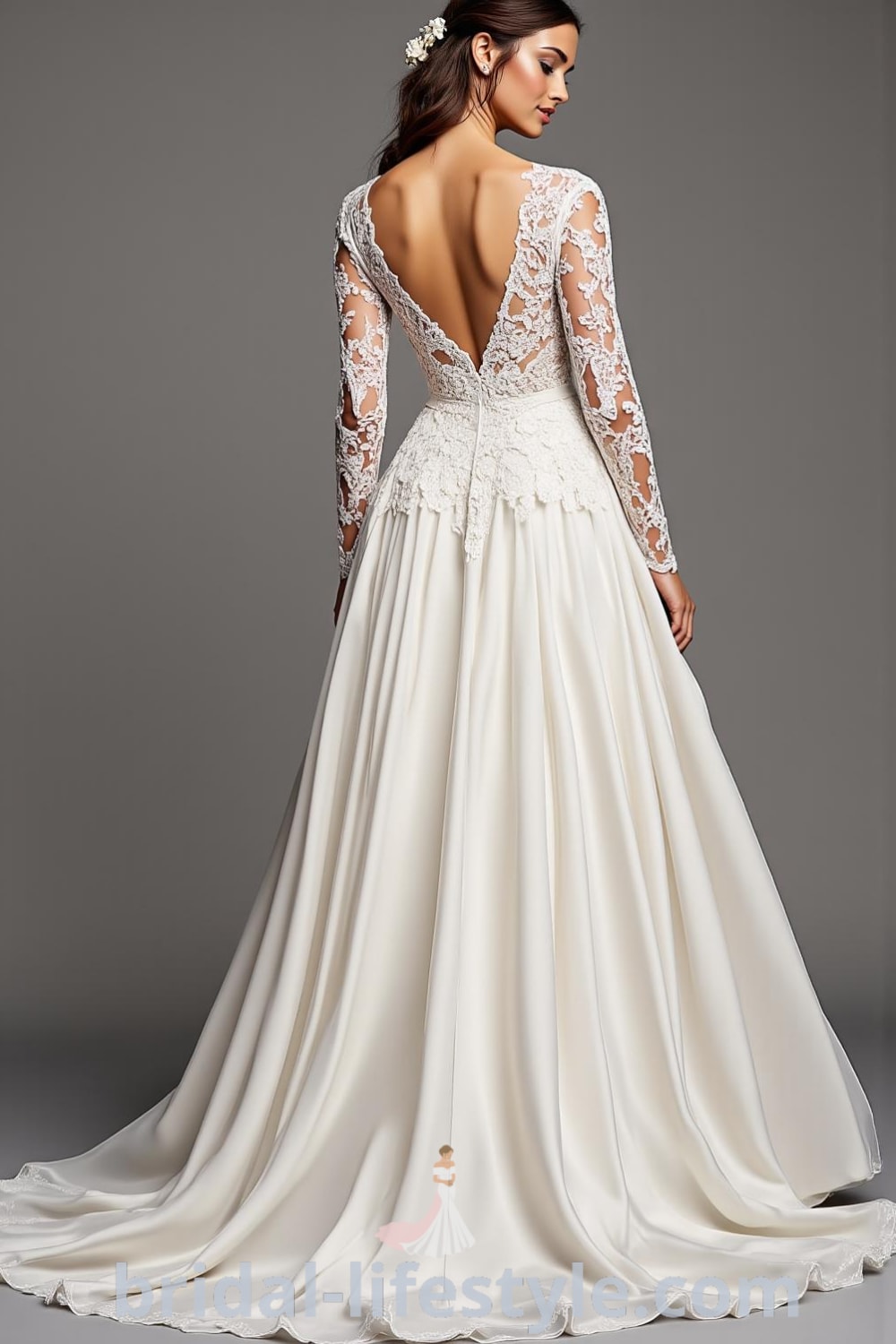 A-line wedding dress with long lace sleeves, intricate floral appliqués on the bodice, and a soft satin skirt flowing elegantly. Features a subtle scoop back for added timeless appeal. bridal-lifestyle.com