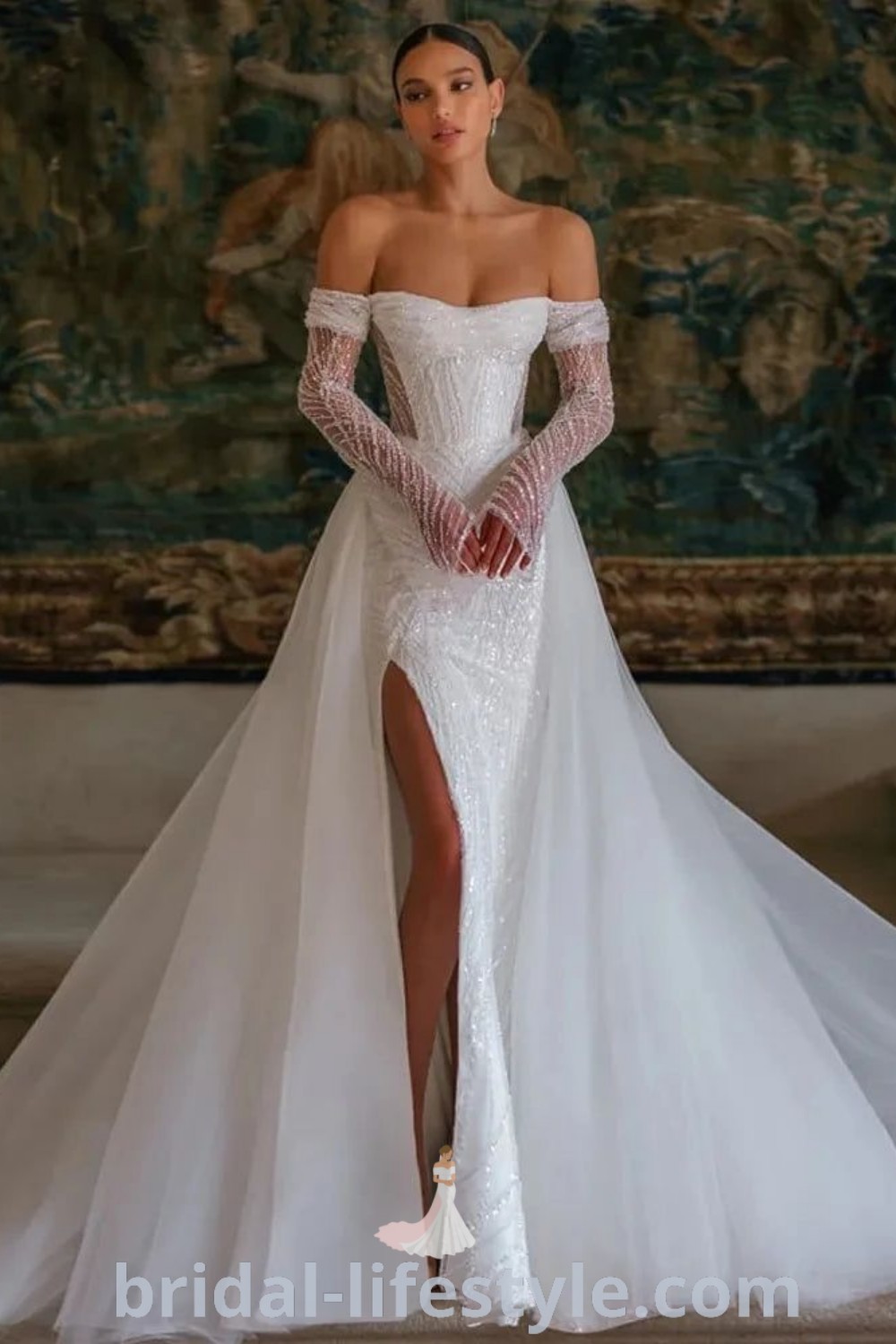 An elegant mermaid wedding dress ideal for hourglass figures, featuring a stunning long train and off-the-shoulder design, perfect for the special day. Discover the dreamiest bridal trends and the best aesthetic ideas for tattooed brides at bridal-lifestyle.com.