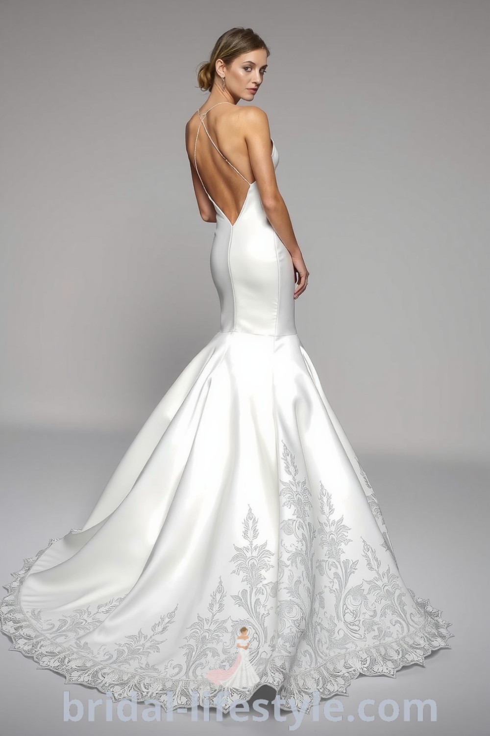 Mermaid wedding dress with fitted satin bodice, open back, and intricate lace detailing, showcasing elegance and dreamy aesthetics for the special day. bridal-lifestyle.com