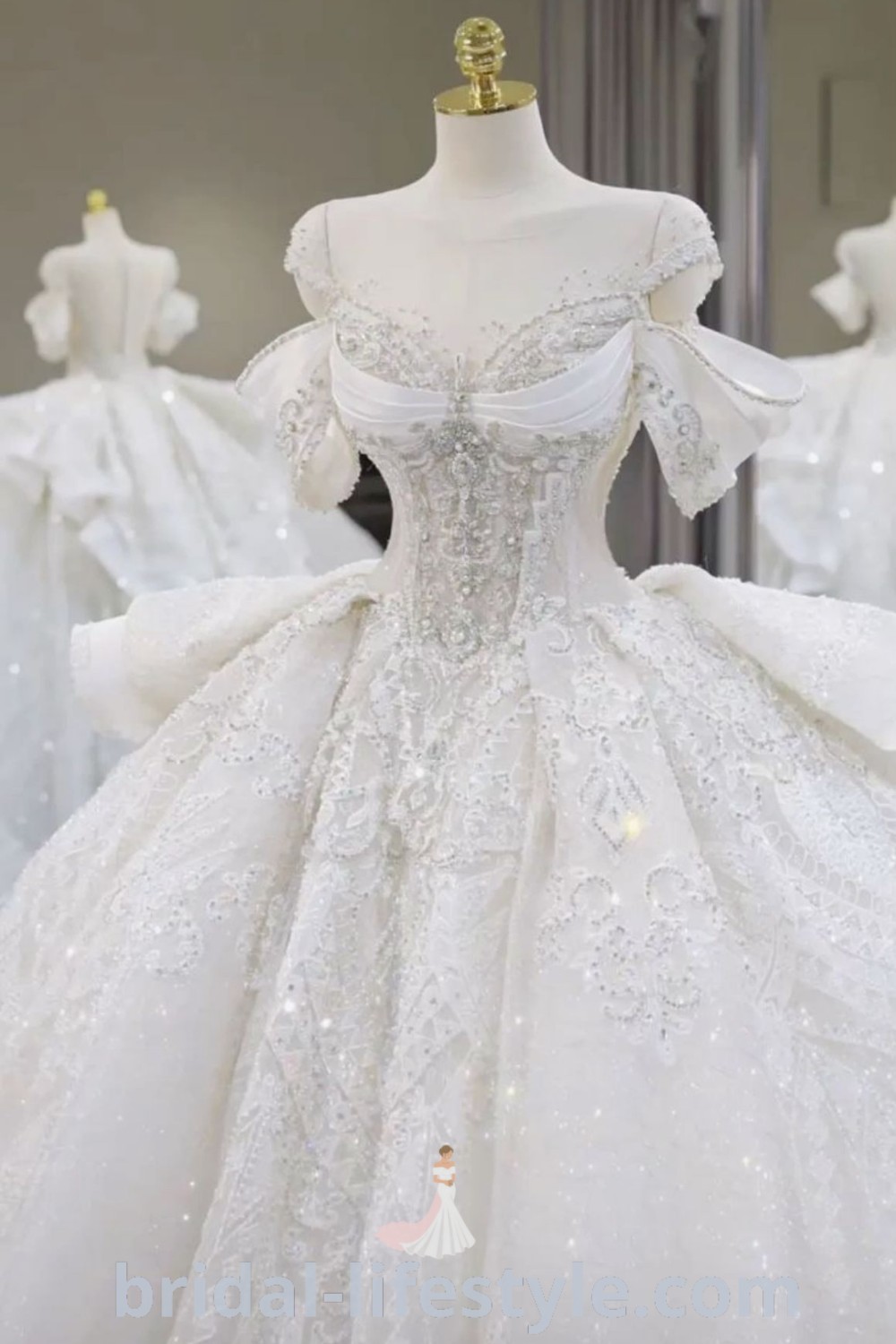 A stylish white wedding dress on display in a room with mannequins, representing dramatic and fancy wedding dress trends. Ideal for dreamy brides seeking chic outfit ideas and inspiration for their special day, this gown embodies elegance and romance. Find perfect bridal aesthetics at bridal-lifestyle.com.