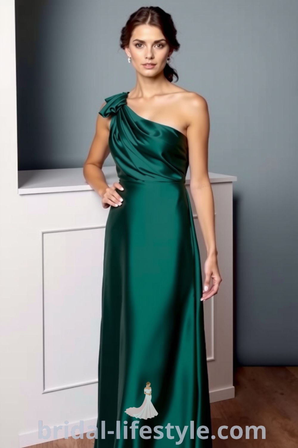 One shoulder bridesmaid dress in deep emerald, made of soft satin with an asymmetrical neckline and subtle pleats, perfect for elegant wedding inspiration. bridal-lifestyle.com