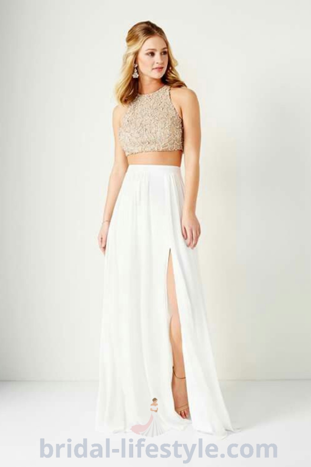 A woman wearing a chic two-piece dress with a high slit skirt and crop top, ideal for wedding guests, rehearsal dinners, and henna nights. This elegant outfit showcases the best bridal trends for dreamy brides, providing inspiration looks and aesthetic ideas for every bride