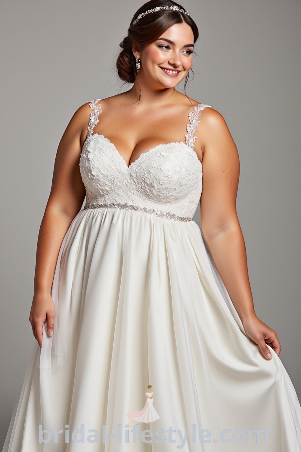A-line wedding dress for plus-size brides with satin bodice, lace appliqués, and tulle skirt, featuring a sweetheart neckline and embellished straps. bridal-lifestyle.com