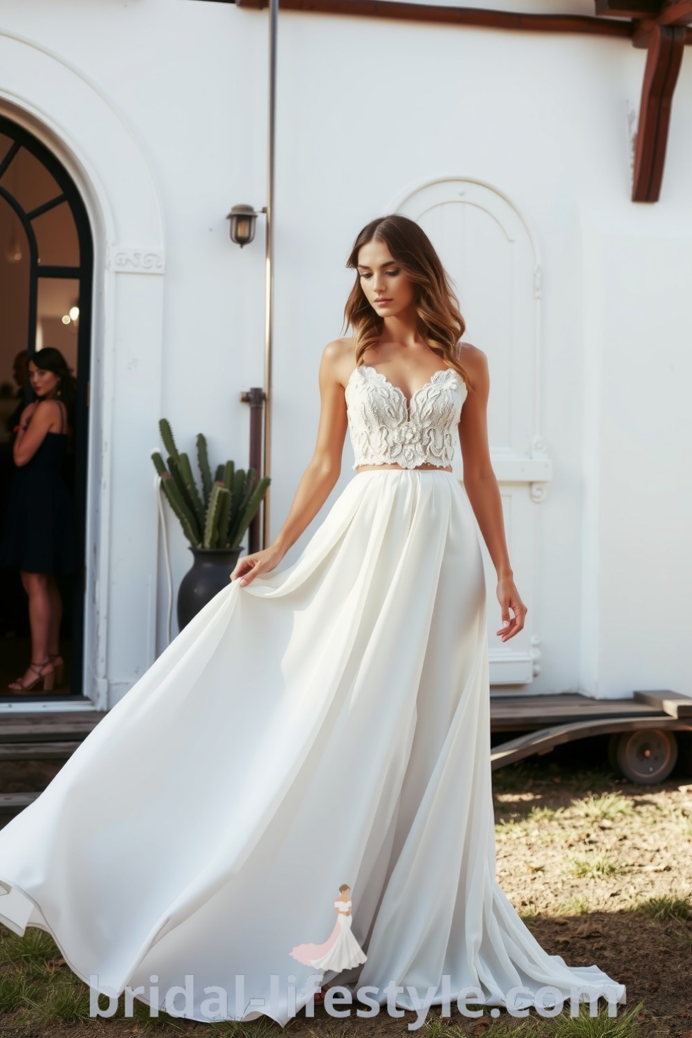 Boho two-piece wedding dress with lace crop top, embroidered floral details, and a flowing chiffon skirt, designed for a romantic outdoor wedding. bridal-lifestyle.com