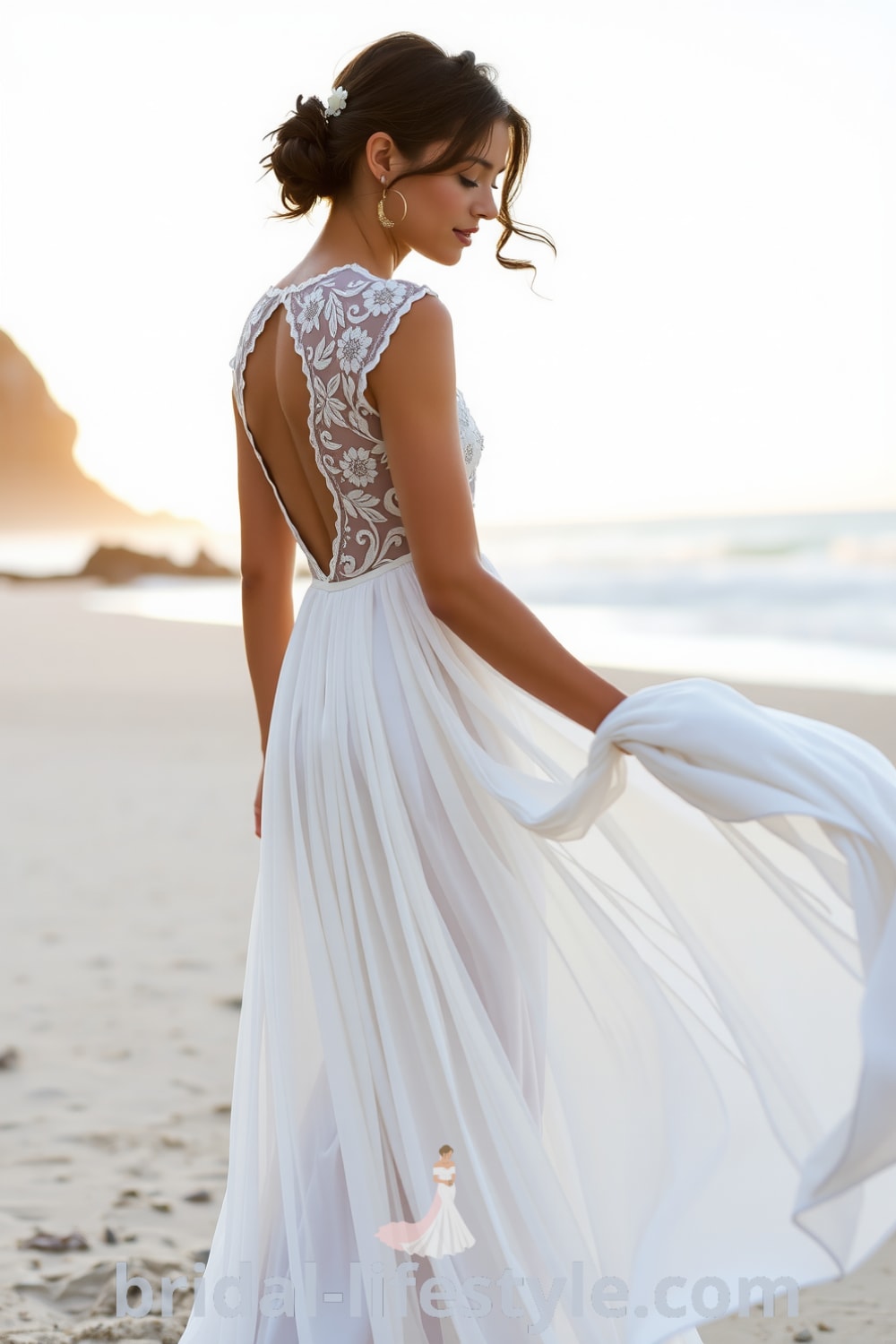 A boho beach wedding dress made of ethereal lace and chiffon, featuring a plunging back, delicate cap sleeves with floral embroidery, perfect for a sunset ceremony by the ocean. bridal-lifestyle.com