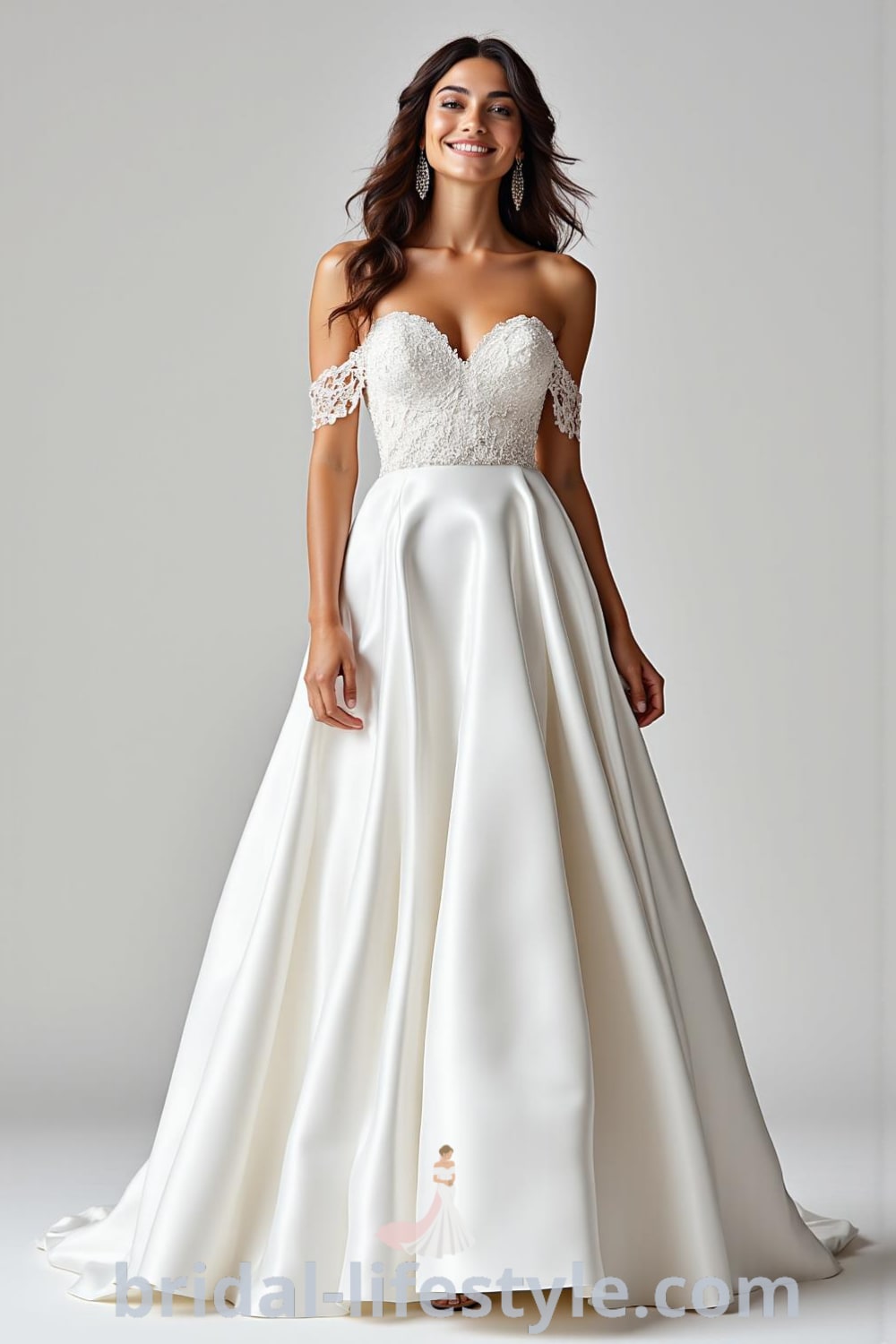 Off-the-shoulder A-line wedding dress made of satin, featuring lace appliqués and bead detailing, with a flowing skirt. bridal-lifestyle.com