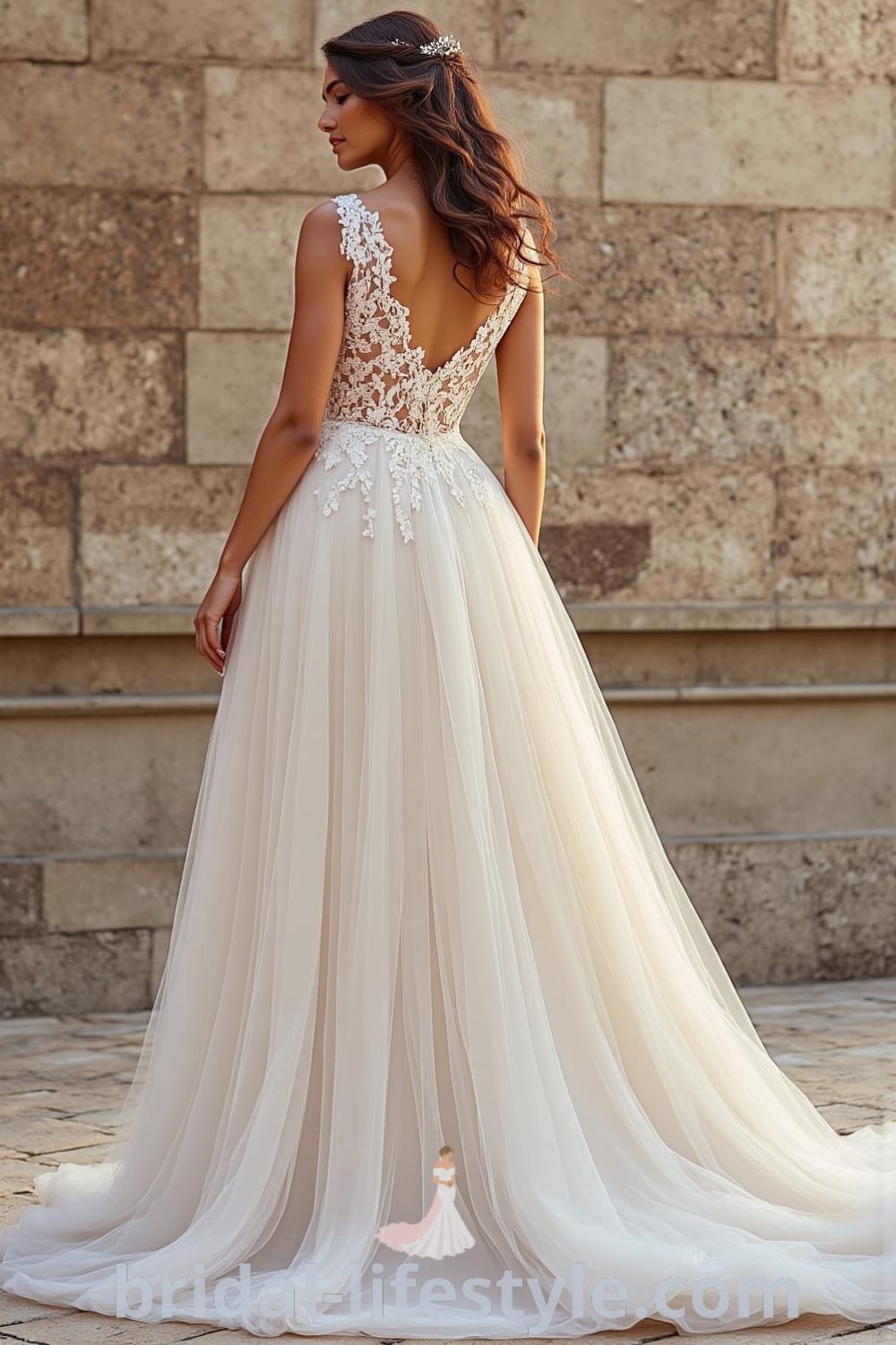 A-line wedding dress featuring an intricate lace bodice, delicate tulle skirt, sweetheart neckline, and a gracefully draped back with lace detailing. bridal-lifestyle.com