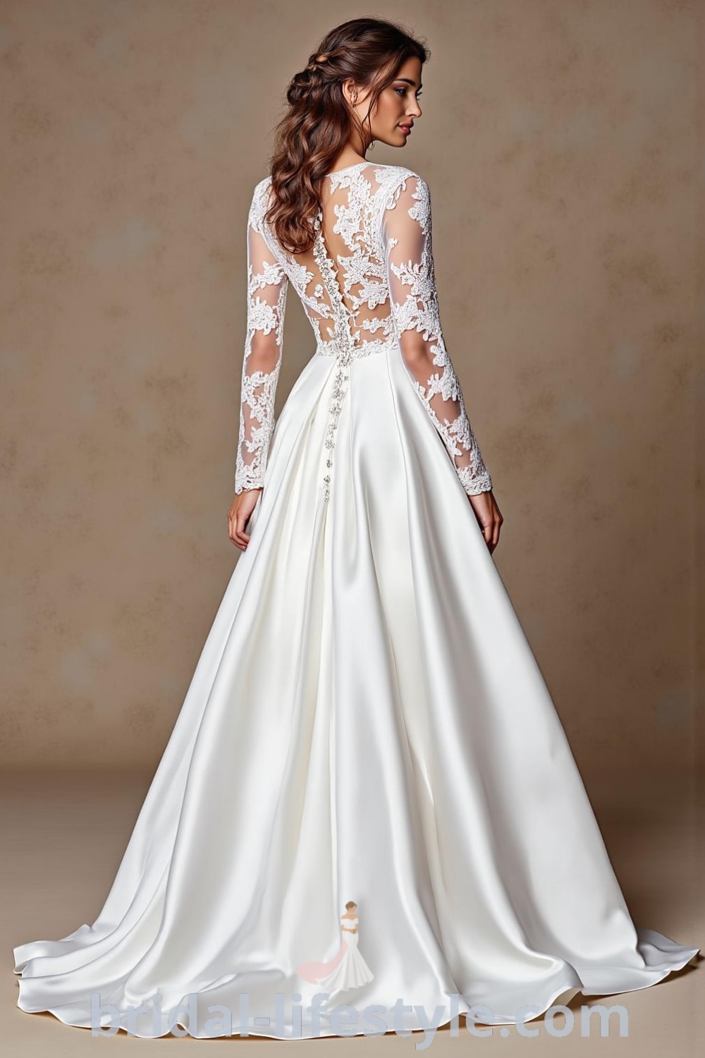 A-line wedding dress with long sheer lace sleeves, soft satin skirt, floral lace bodice, and a row of buttons at the back. bridal-lifestyle.com