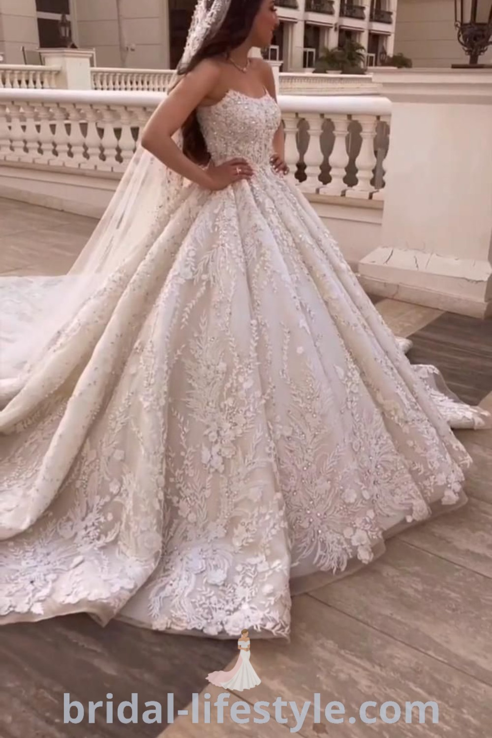 An elegant ballgown wedding dress with sleeves, adorned with 3D floral embellishments and pearl embroidery, showcasing the latest trends for 2023. This stunning gown is ideal for summer weddings and perfect for dreamy brides. Find the best bridal inspiration and elegant styles at bridal-lifestyle.com.