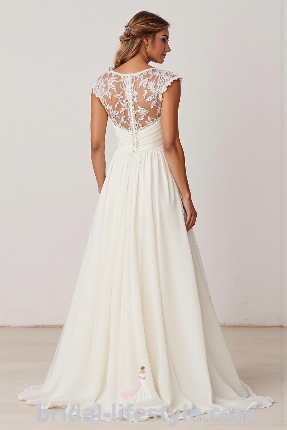 Elegant A-line wedding dress with boat neck, satin bodice, chiffon skirt, cap sleeves, lace appliqués, and illusion back featuring buttons. bridal-lifestyle.com