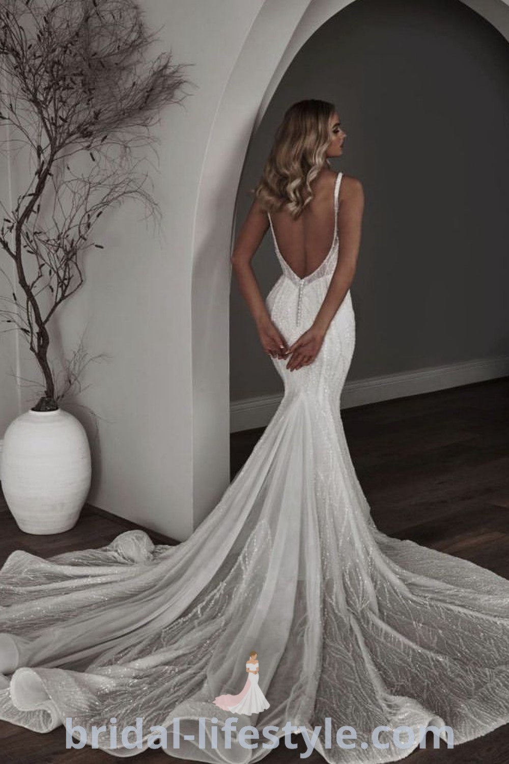 An elegant white wedding dress with an open back and sequin details, ideal for chic brides seeking 2024 trends. This stunning gown embodies romance and sophistication, making it a perfect choice for the special day. Discover more bridal inspiration at bridal-lifestyle.com.