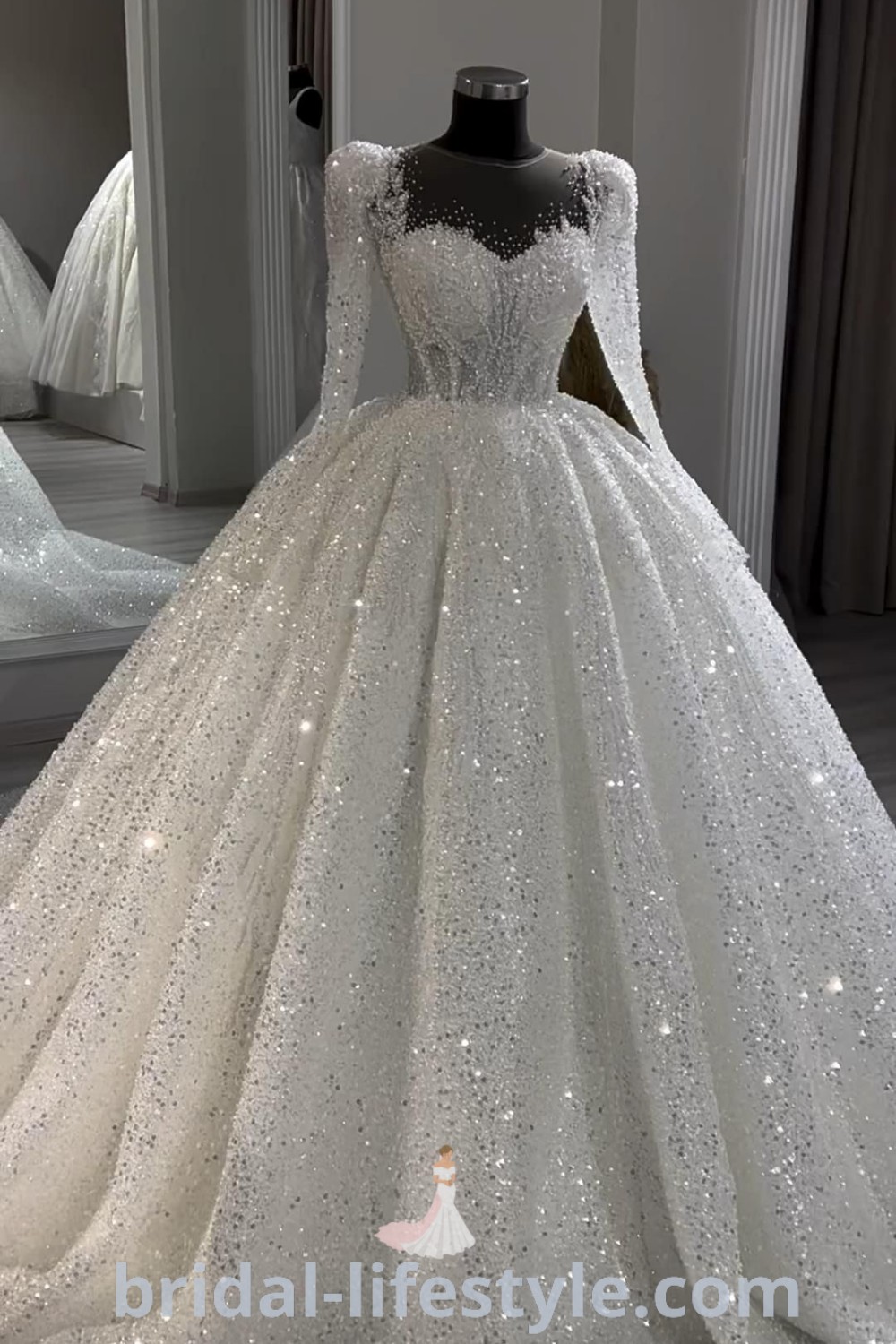 An elegant white wedding dress with modest long sleeves and a sparkling ballgown silhouette, perfect for dreamy brides. This stunning dress represents the best bridal trends and aesthetic ideas for the special day, featured at bridal-lifestyle.com.