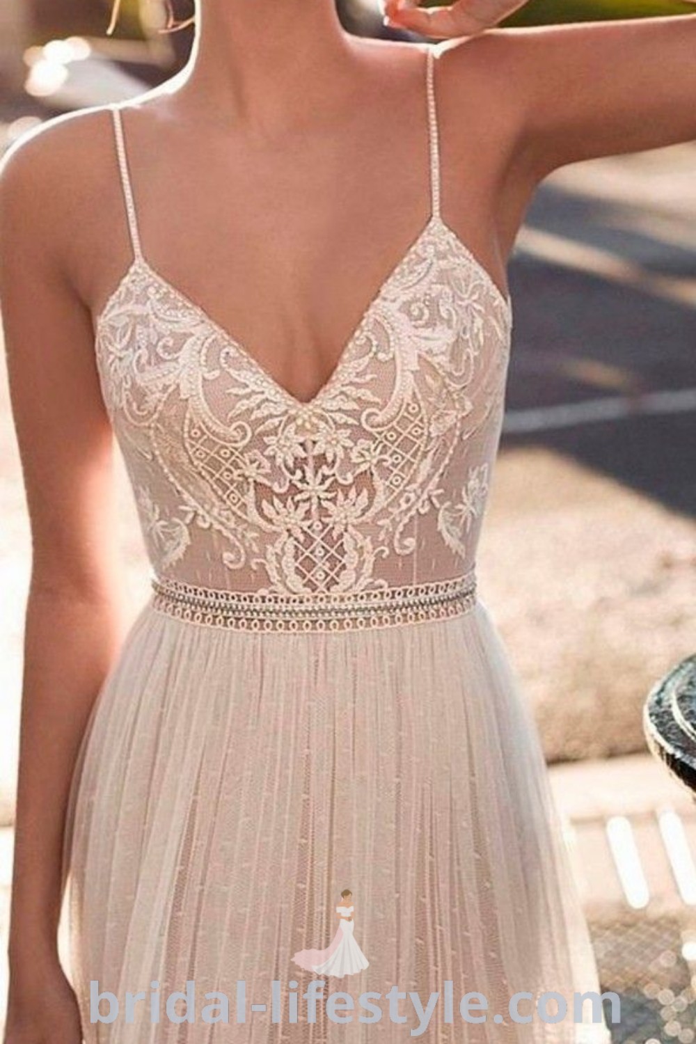 A woman in a white boho bridal dress poses gracefully for the camera, capturing the elegance of Beach Wedding Dresses. This gown reflects current bridal trends and offers aesthetic ideas for brides seeking inspiration for their special day. Discover more at bridal-lifestyle.com.