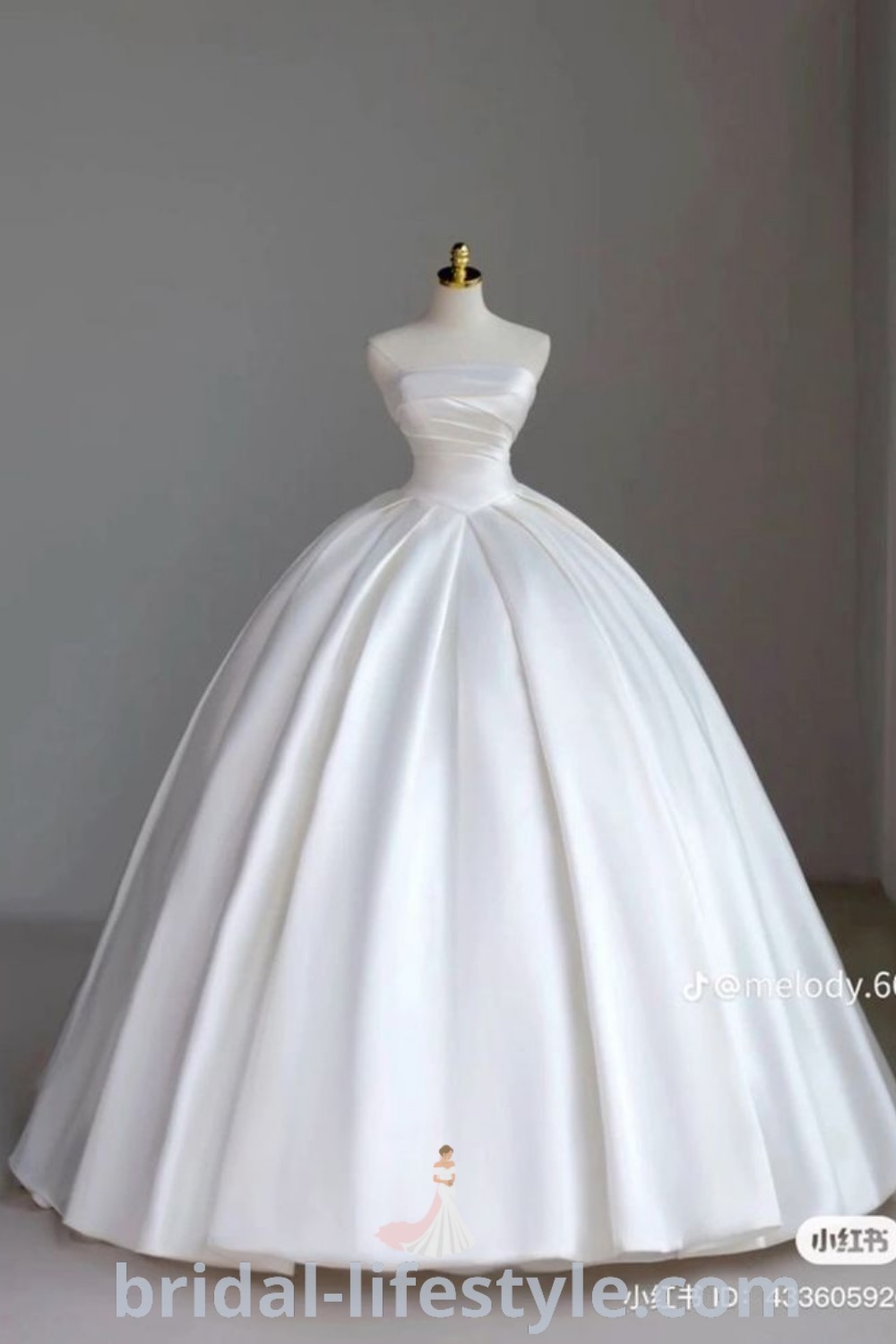 An elegant white wedding dress on display, reminiscent of classic Cinderella designs. This satin ballgown features stunning details, making it ideal for romantic and fairytale-inspired weddings. Perfect for brides seeking inspiration looks and vintage bridal dresses for their special day at bridal-lifestyle.com.