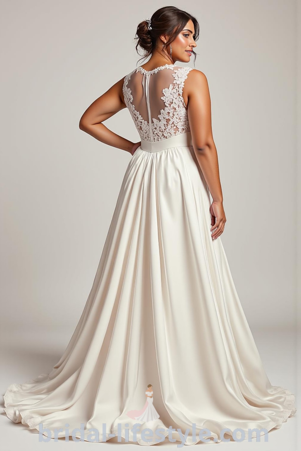 Elegant plus-size A-line wedding dress featuring a satin bodice with floral lace appliqués, a flowing skirt, an illusion neckline, and a tie detail at the back. bridal-lifestyle.com
