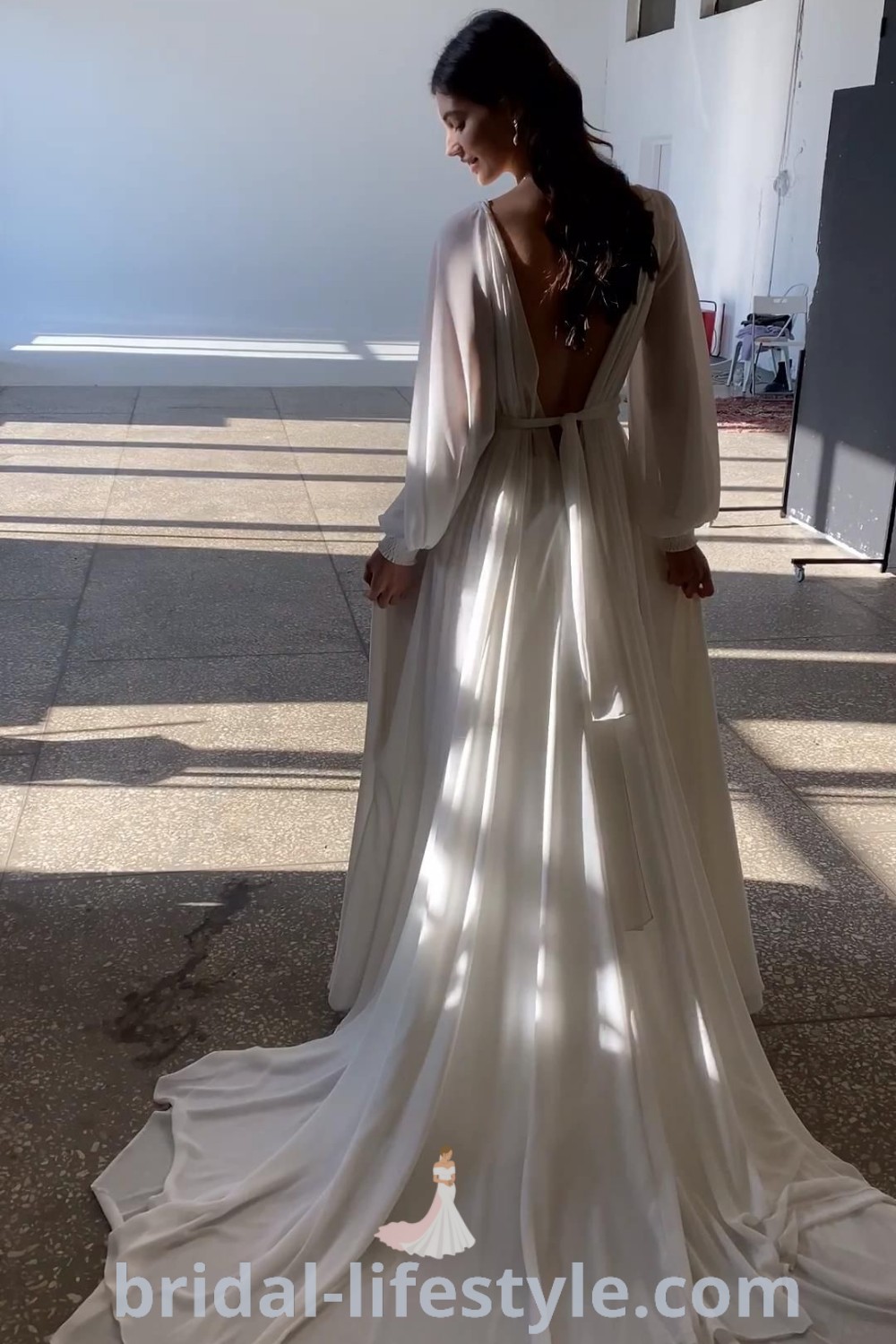 An elegant long sleeve wedding dress with flowy sleeves and a detachable skirt, ideal for bridal trends and for dreamy brides. This romantic gown offers the best aesthetic ideas for the special day, blending style and comfort. Explore more inspiration at bridal-lifestyle.com.