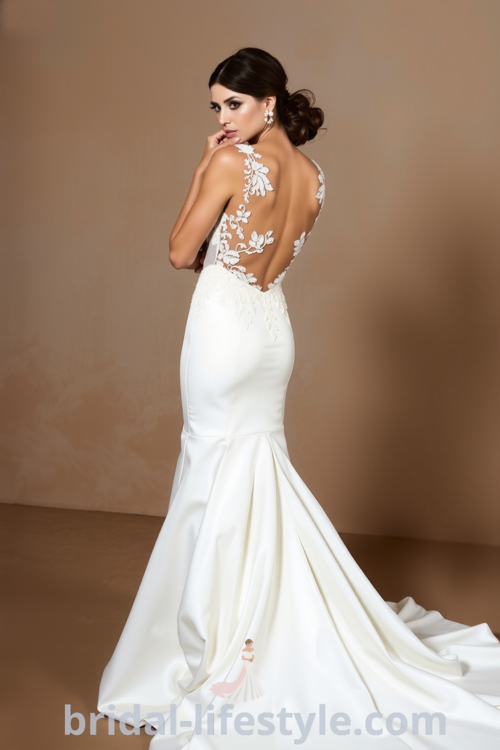 Fit and flare wedding dress in luxurious satin, featuring an open back and delicate lace appliqués on the bodice, embodying elegance and sophistication. bridal-lifestyle.com