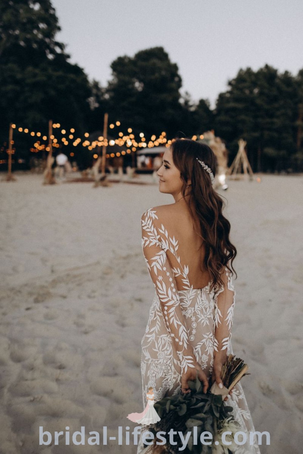 A woman standing on a sandy beach, holding a bouquet and wearing a beachy wedding dress, ideal for boho beach weddings and cute cowgirl outfits, perfect for dreamy brides. Find inspiration for the best beach wedding looks at bridal-lifestyle.com.