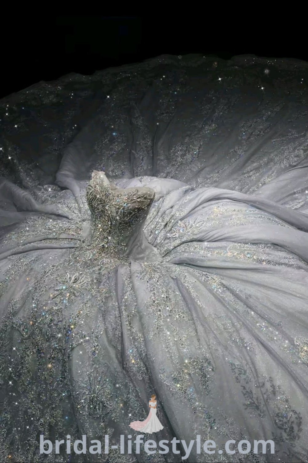 A white wedding dress with silver sequins on the skirt is elegantly displayed, showcasing a puffy, extravagant design ideal for big wedding celebrations. Perfect for dreamy brides looking for inspiration and the best dress trends, this gown is featured on bridal-lifestyle.com.