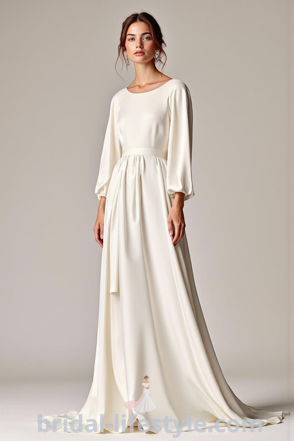 Minimalist long sleeve wedding dress made of luxurious satin, featuring a round neckline and flowing skirt, designed for a sleek silhouette. bridal-lifestyle.com