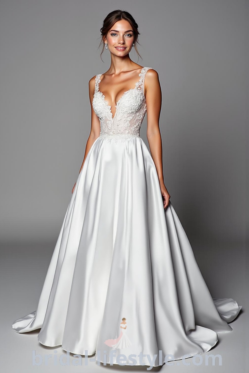 A-line wedding dress with modest V-neckline, lace bodice, flowing satin skirt, floral appliqués, and intricate lace illusion back. bridal-lifestyle.com