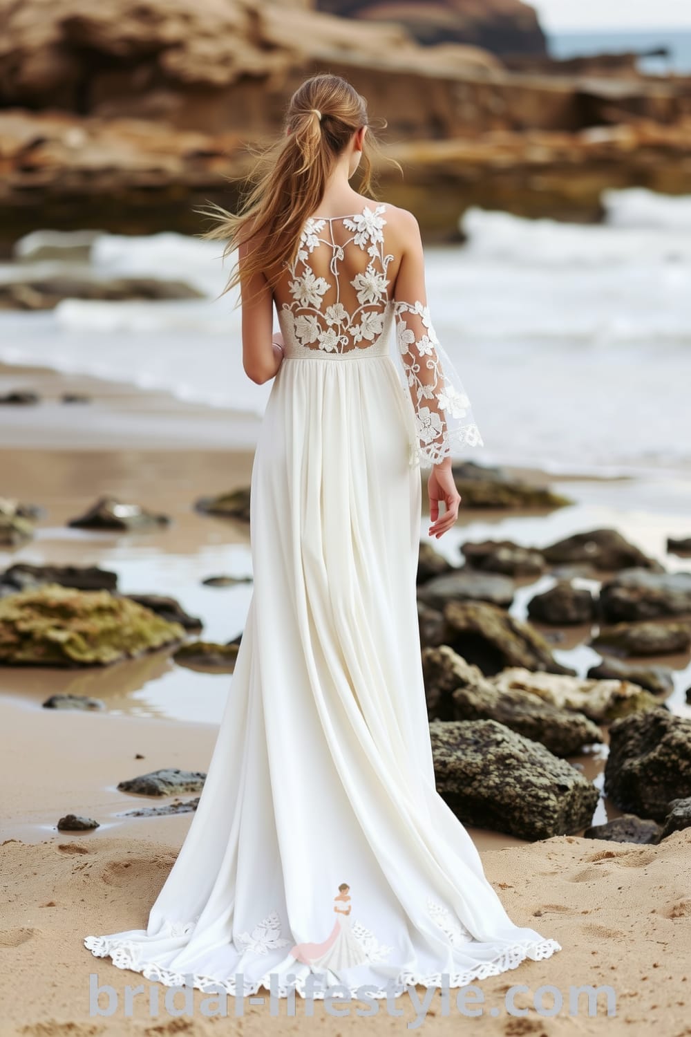 Boho beach wedding dress made of cotton lace with floral appliqués on the bodice, flowing ethereal skirt, bell sleeves, and an open back. bridal-lifestyle.com