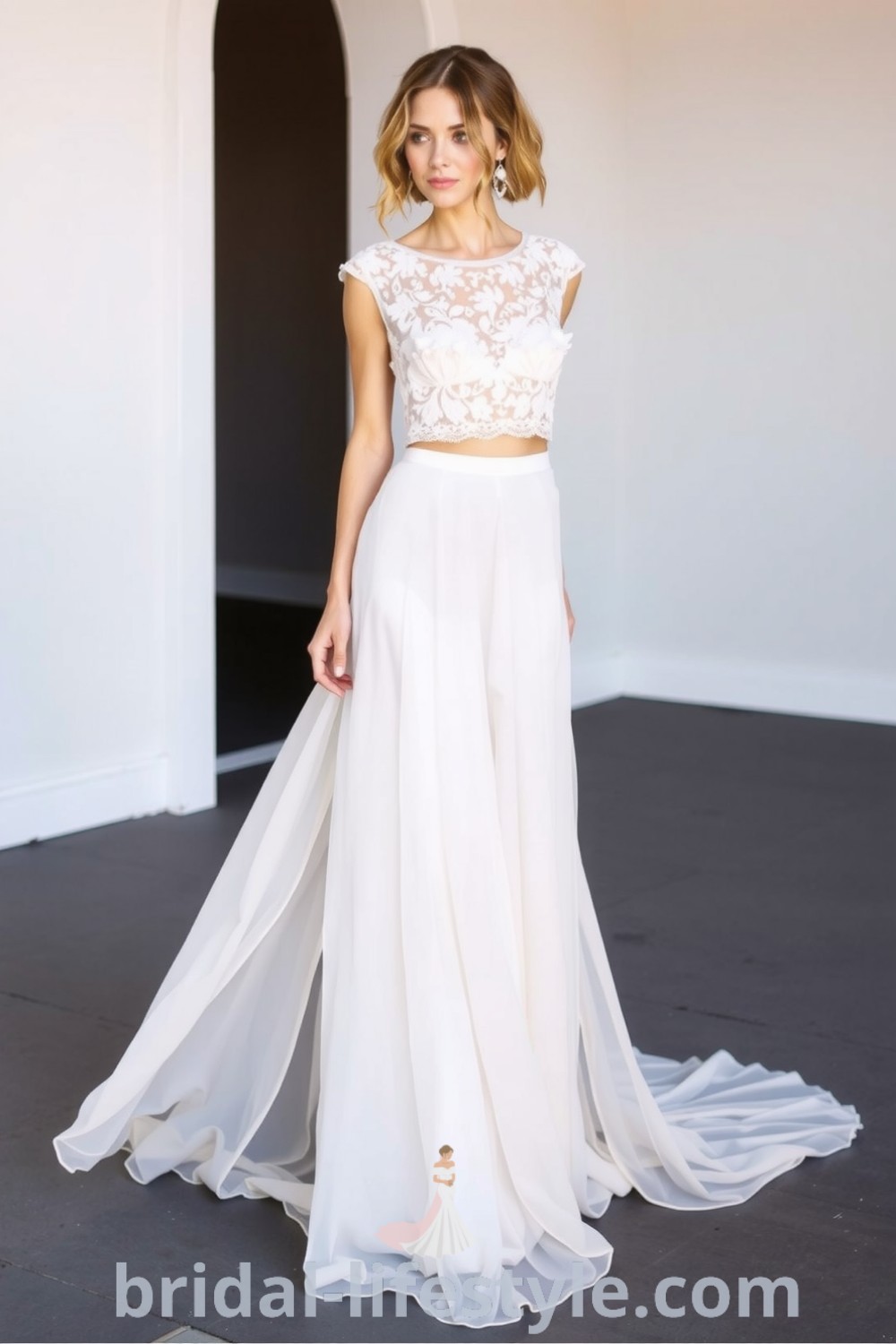 Boho two-piece wedding dress with a cropped lace top and flowing chiffon skirt, featuring delicate floral lace detailing for an elegant silhouette. bridal-lifestyle.com