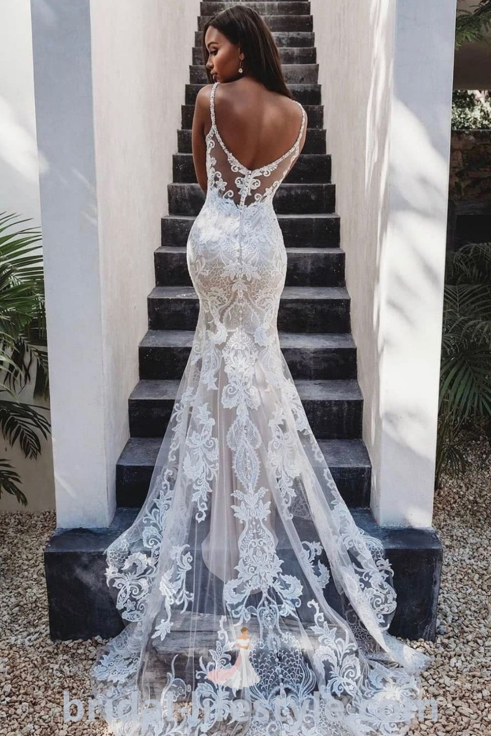 An elegant backless wedding dress with a mermaid silhouette, perfect for brides looking for a fitted and sophisticated style. This stunning design is featured on bridal-lifestyle.com, showcasing the best wedding dress ideas and trends for a romantic celebration.