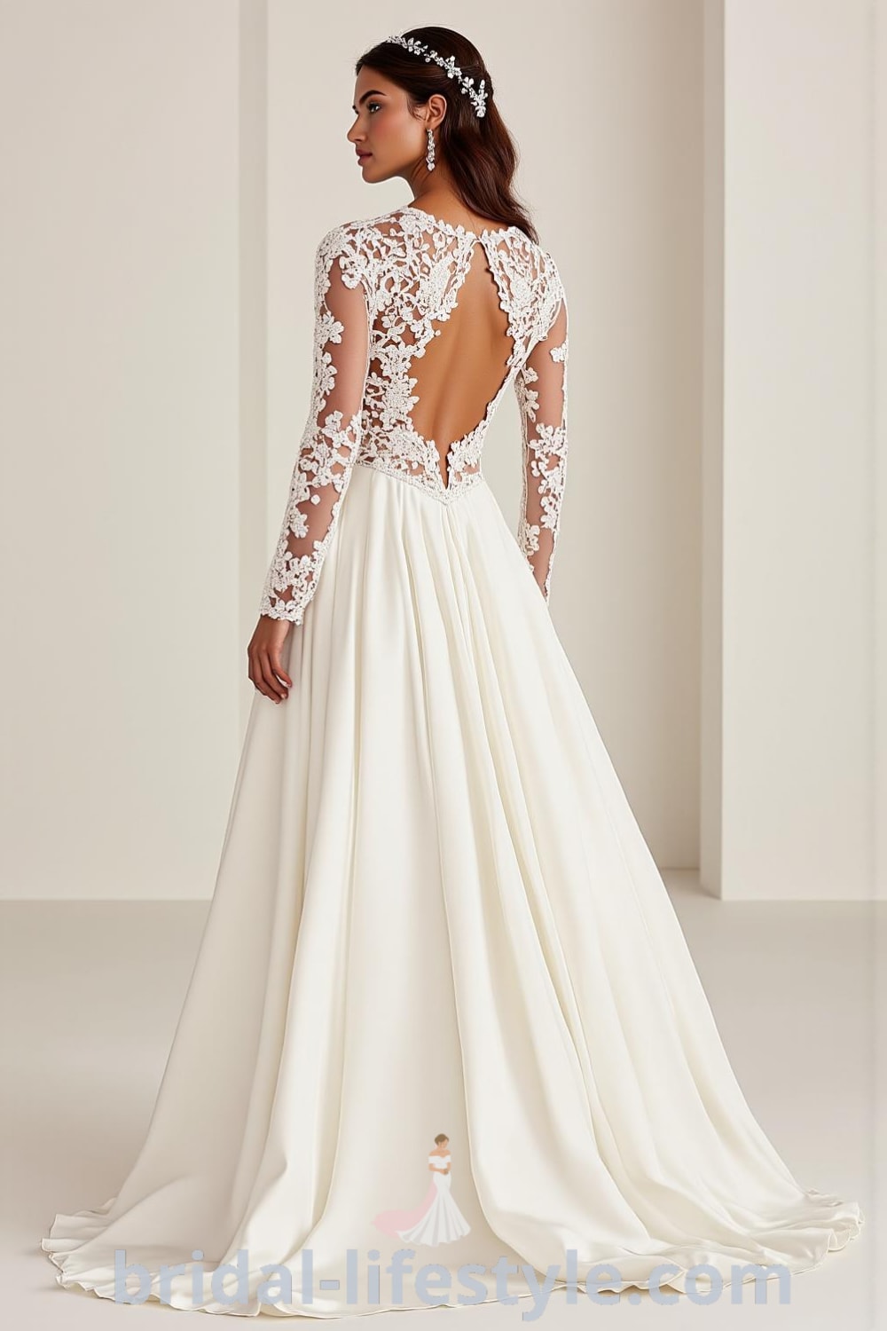A-line wedding dress featuring long lace sleeves, an illusion neckline, a flowing satin skirt, intricate lace appliqués, and a keyhole back with button details. bridal-lifestyle.com