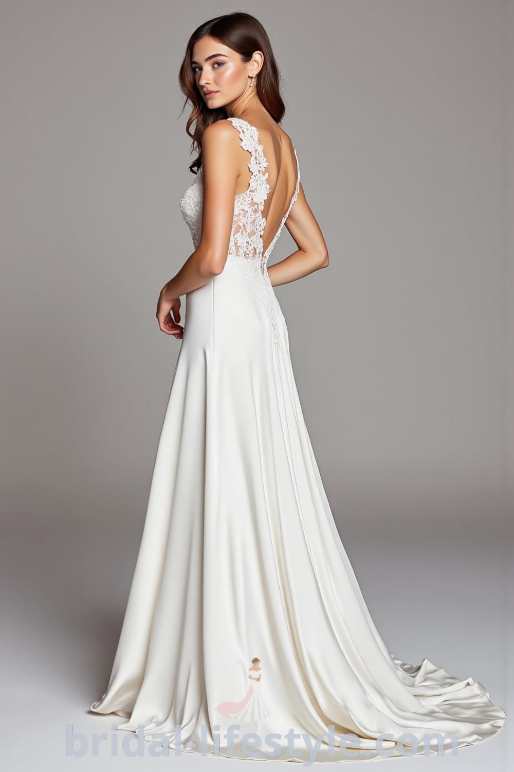 A stunning A-line satin wedding dress with a draped skirt, sweetheart neckline, lace embellishments, and satin-covered buttons at the back. bridal-lifestyle.com