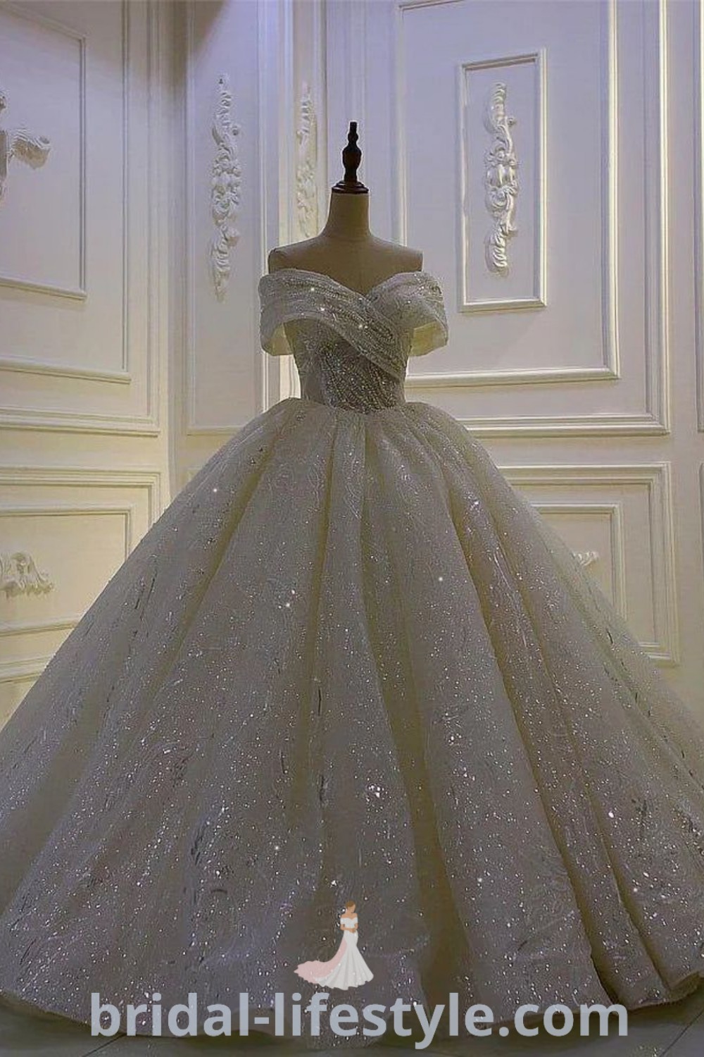 An elegant white ball gown on display in a beautifully decorated room with floor-to-ceiling panels, showcasing bridal trends and inspiration looks for dreamy brides. This stunning gown offers unique aesthetic ideas for the special day, perfect for every bride