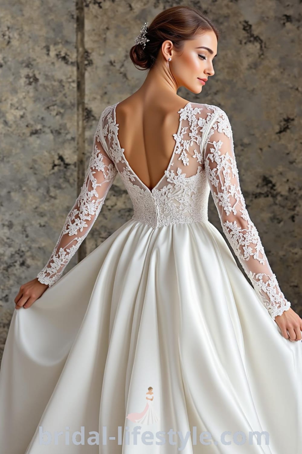 A-line wedding dress with long lace sleeves, flowing satin skirt, embroidered bodice, and a keyhole back. bridal-lifestyle.com