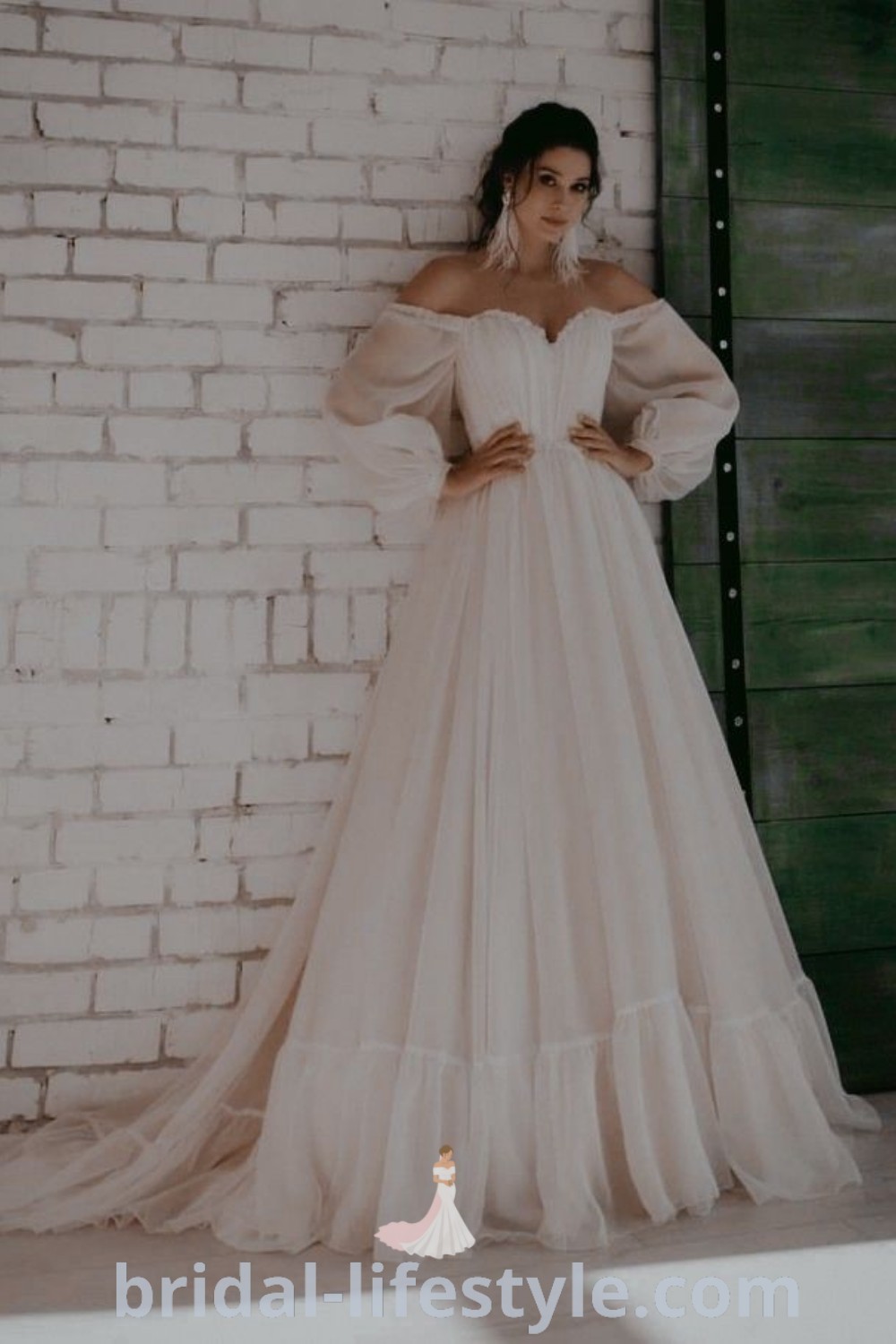 An elegant Over The Shoulder Long Sleeve Wedding Dress with flowy sleeves, perfect for romantic brides seeking an ethereal and stunning look. This chic gown embodies the best wedding dress trends for the special day and offers unique inspiration for brides at bridal-lifestyle.com.