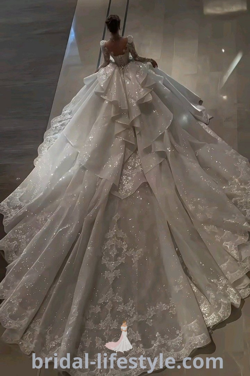 An elegant woman in a luxurious white wedding dress walks down the runway, showcasing extravagant wedding styles. This gown is part of the best trends in bridal fashion, perfect for dreamy brides seeking aesthetic ideas for their special day. Discover more at bridal-lifestyle.com.