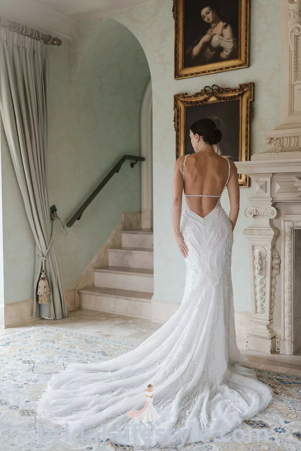 An elegant beaded low back wedding dress designed for dreamy brides, featuring a unique fit and flare silhouette and spaghetti straps. This stunning gown is perfect for the special day, combining comfort and style. Discover more inspiring wedding dress ideas at bridal-lifestyle.com.