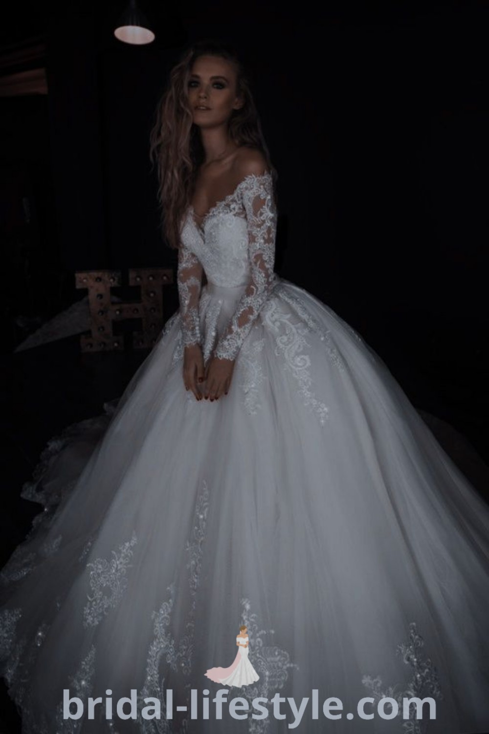 A woman wearing a white wedding dress in the dark, showcasing elegant features and romantic lace details, perfect for brides seeking inspiration for their special day. Explore more at bridal-lifestyle.com.